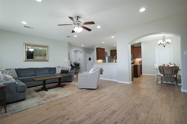 living room with ceiling fan and light wood-type flooring