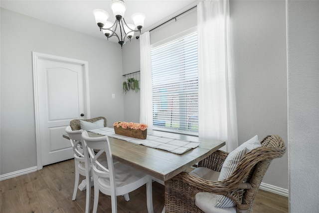 dining room featuring a chandelier and light hardwood / wood-style flooring