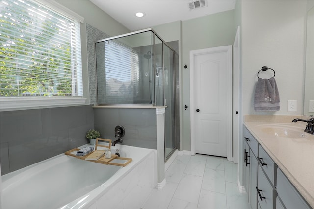 bathroom featuring vanity and separate shower and tub