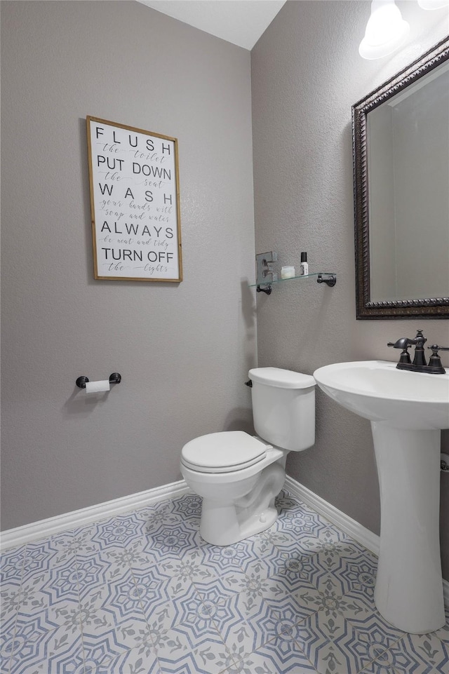 bathroom featuring toilet and tile patterned flooring