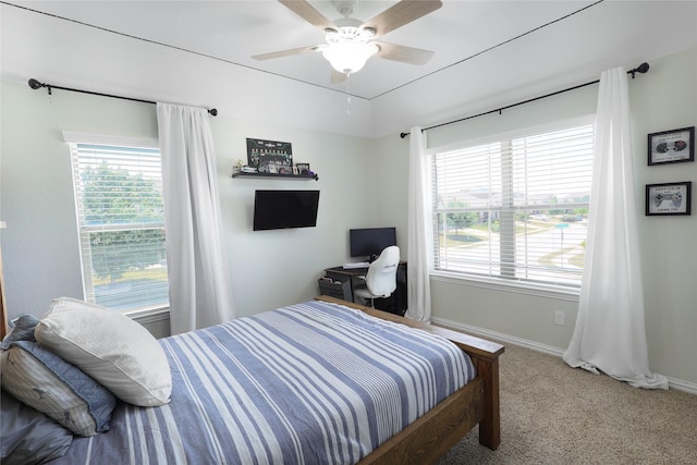 carpeted bedroom with multiple windows and ceiling fan