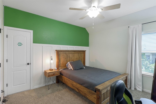 carpeted bedroom featuring multiple windows, vaulted ceiling, and ceiling fan