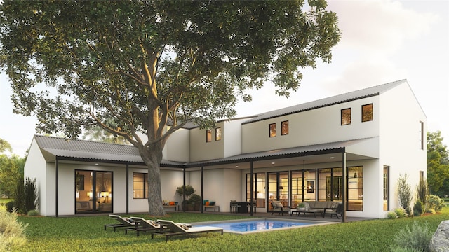 rear view of house with a yard, an outdoor hangout area, and a patio area