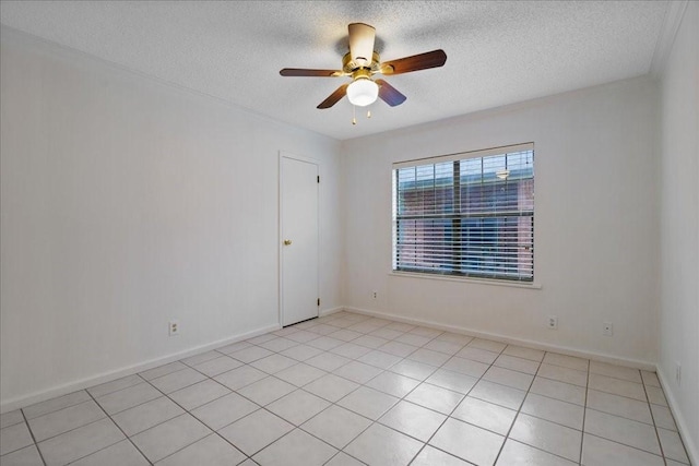 tiled empty room with ceiling fan and a textured ceiling