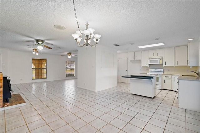 kitchen with pendant lighting, white cabinets, white appliances, and light tile patterned floors