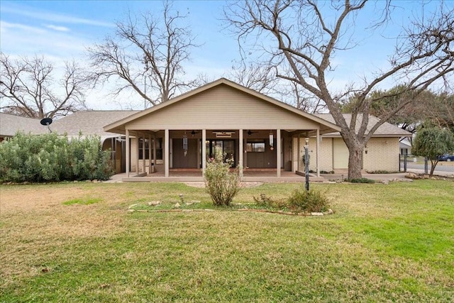 back of house with a patio and a yard