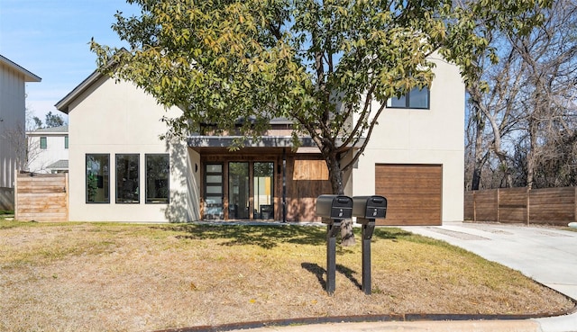 view of front of property with a garage and a front yard