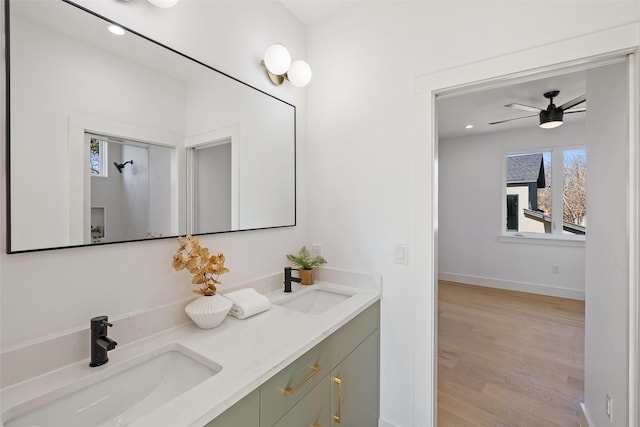 bathroom with hardwood / wood-style flooring, ceiling fan, and vanity