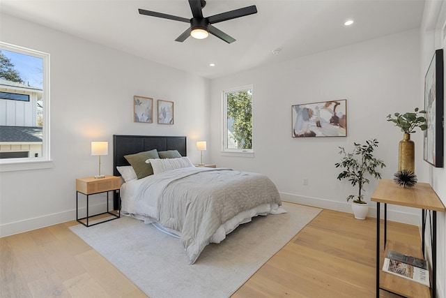 bedroom with ceiling fan and light hardwood / wood-style flooring