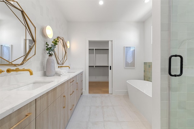 bathroom featuring vanity and separate shower and tub