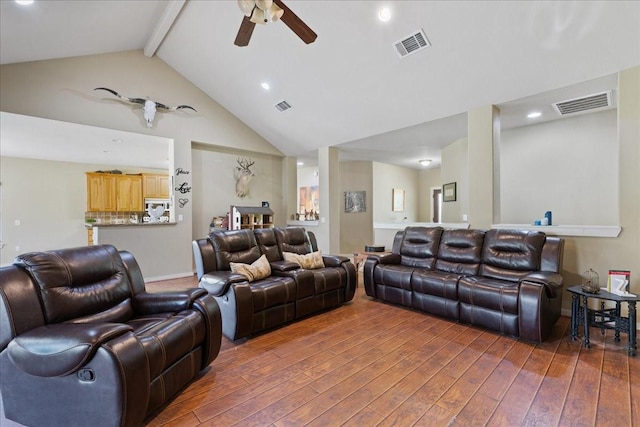 home theater room featuring lofted ceiling with beams and ceiling fan