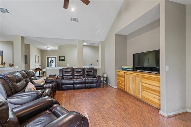 living room featuring hardwood / wood-style flooring, vaulted ceiling, and ceiling fan