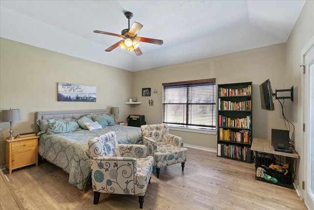 bedroom featuring a tray ceiling, light hardwood / wood-style flooring, and ceiling fan