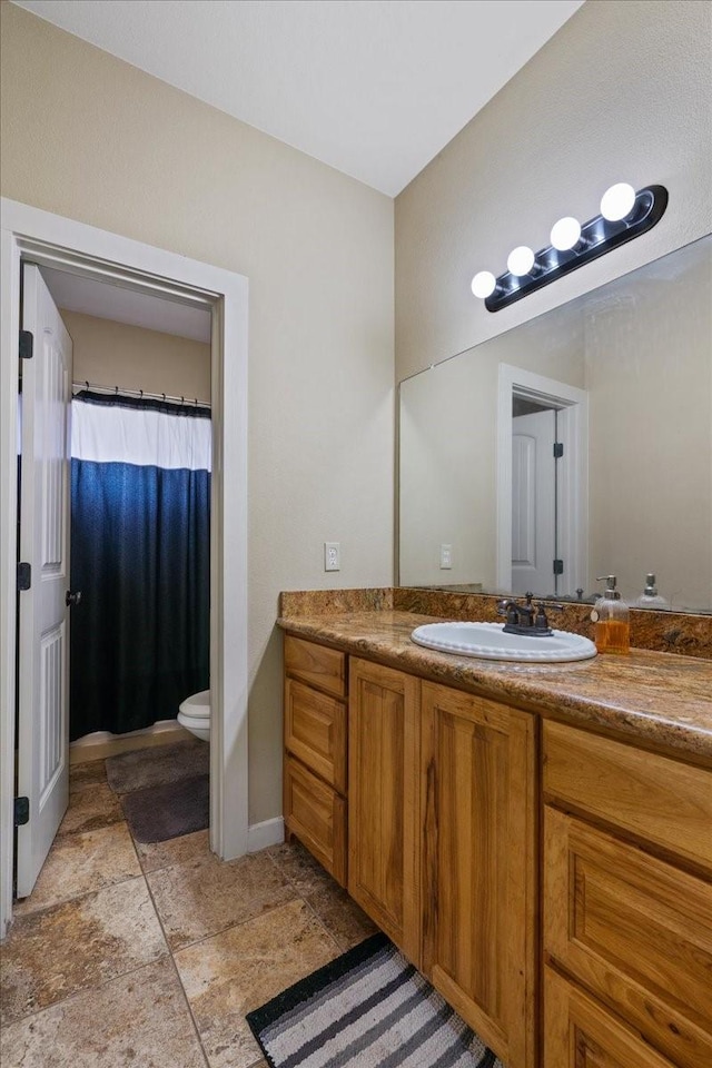 bathroom featuring vanity and toilet