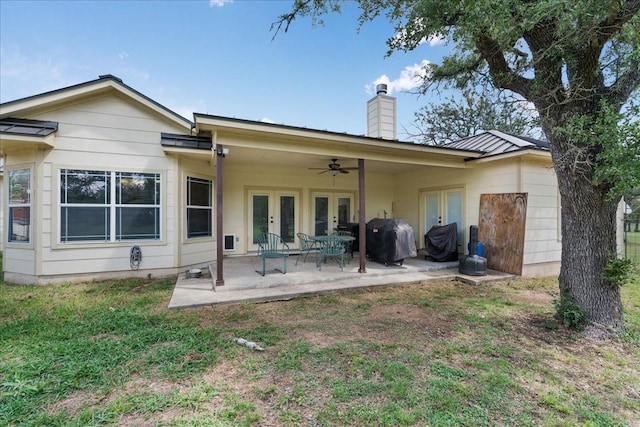 rear view of house featuring french doors, ceiling fan, and a patio