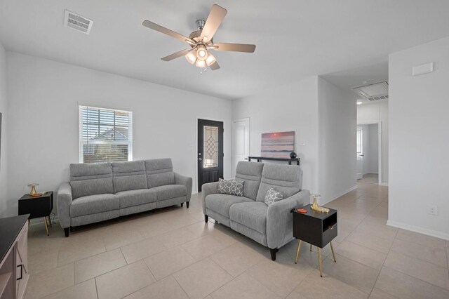 305 Ravens Crest Dr, Hutto, TX 78634 - living room featuring light tile patterned floors, attic access, ceiling fan, and baseboards