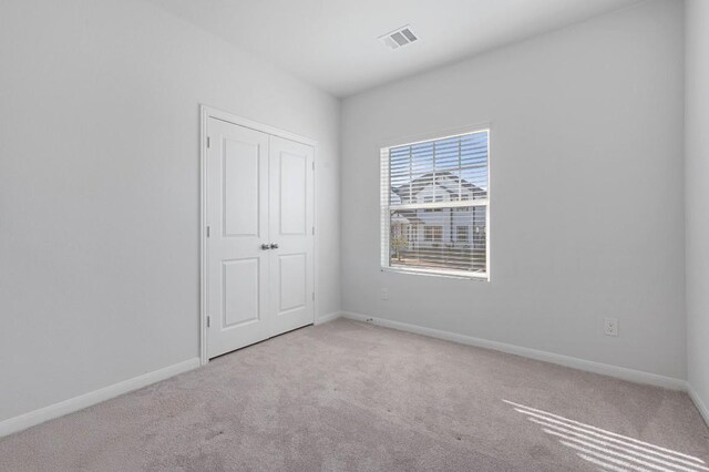305 Ravens Crest Dr, Hutto, TX 78634 - unfurnished bedroom featuring carpet floors, baseboards, and a closet