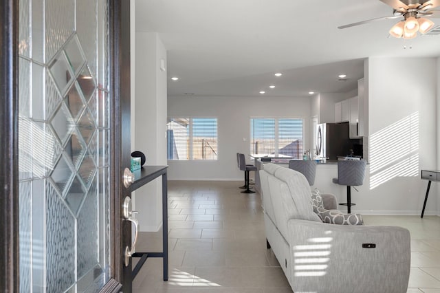 living room with light tile patterned floors and ceiling fan