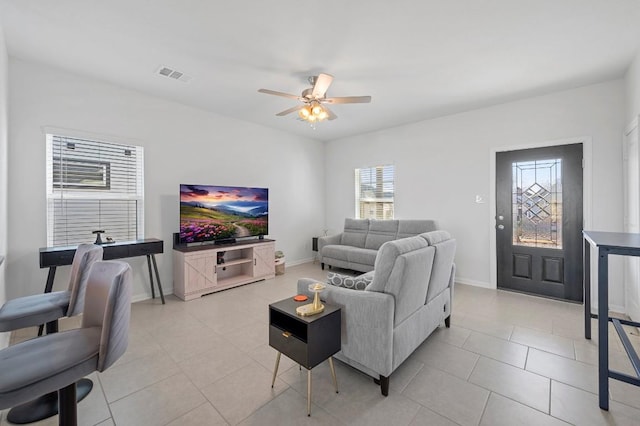 305 Ravens Crest Dr, Hutto, TX 78634 - living area with a ceiling fan, light tile patterned floors, and baseboards