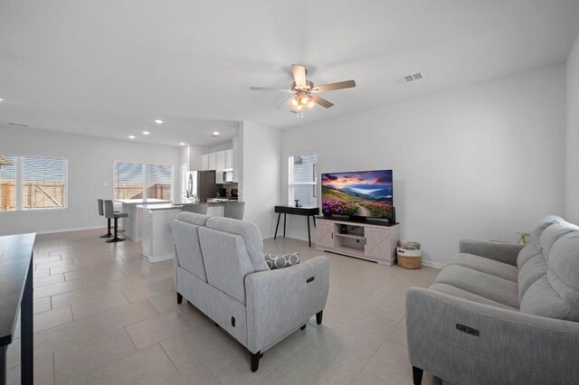 305 Ravens Crest Dr, Hutto, TX 78634 - living area with ceiling fan, recessed lighting, light tile patterned floors, and baseboards