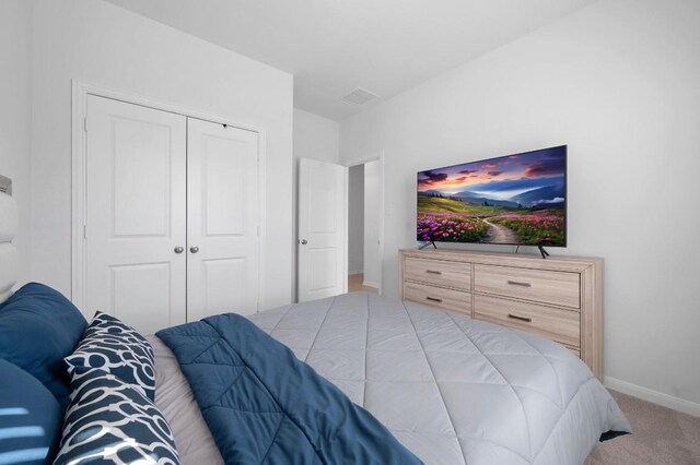305 Ravens Crest Dr, Hutto, TX 78634 - bedroom with carpet flooring, a closet, and baseboards