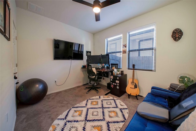 carpeted office featuring ceiling fan