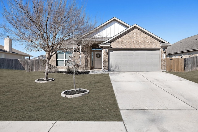 view of front of property with a garage and a front lawn