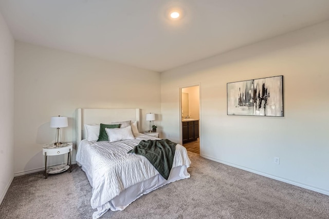 carpeted bedroom featuring ensuite bath