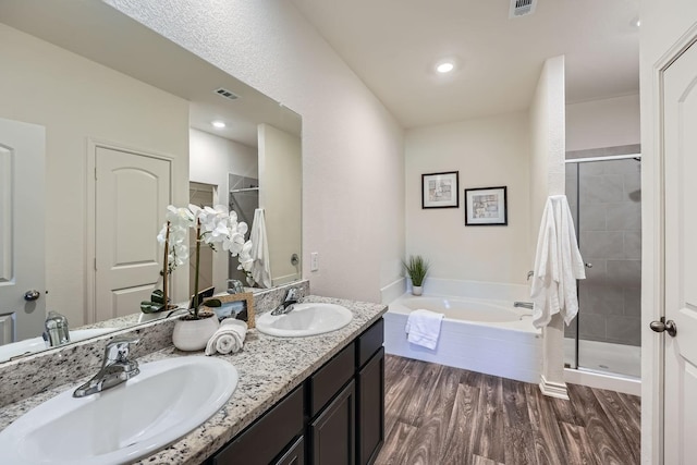 bathroom with vanity, wood-type flooring, and independent shower and bath