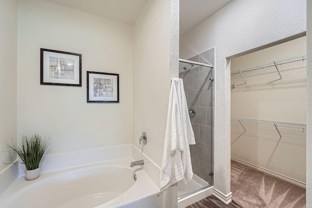 bathroom featuring independent shower and bath