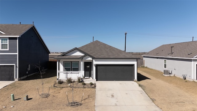 view of front of property featuring central AC, a porch, and a garage