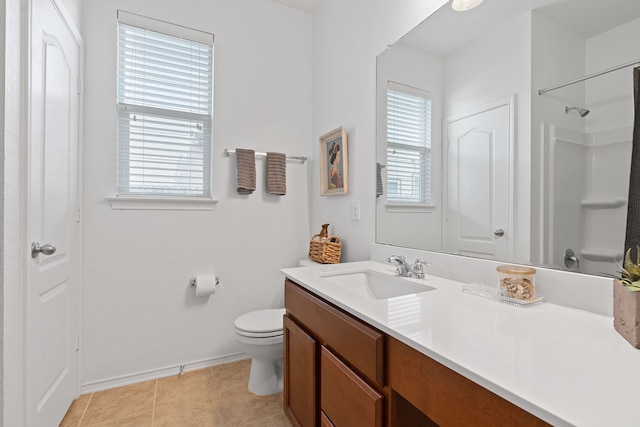 bathroom featuring vanity, walk in shower, tile patterned floors, and toilet