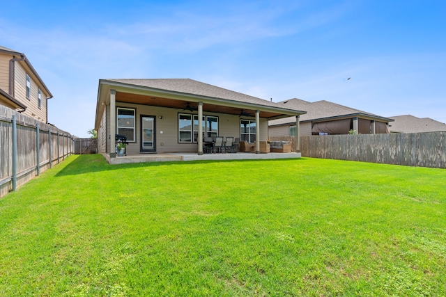 rear view of property with a lawn and a patio area