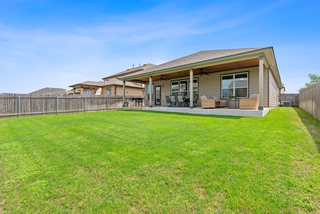 back of property featuring cooling unit, ceiling fan, a yard, and a patio