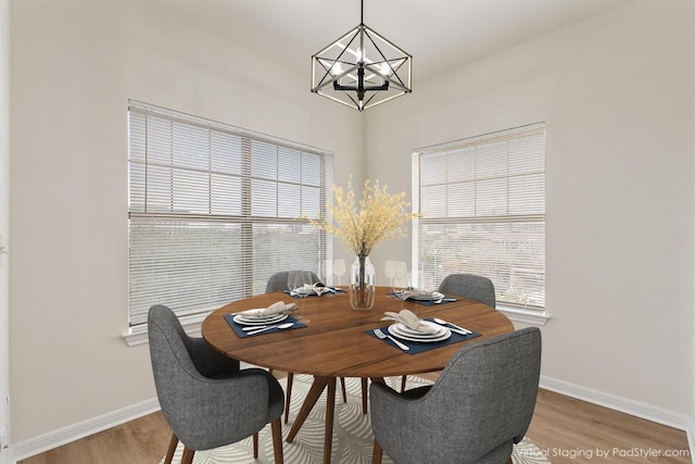 dining area featuring plenty of natural light, light wood-style flooring, and baseboards