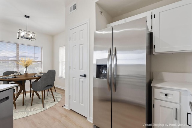 kitchen featuring light wood finished floors, visible vents, white cabinets, and stainless steel fridge with ice dispenser