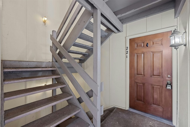 stairway featuring concrete flooring