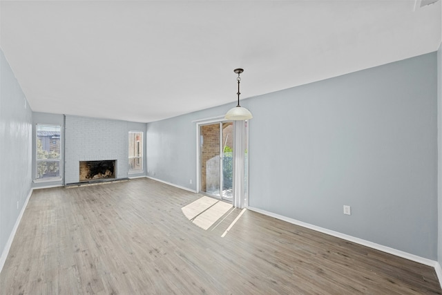 unfurnished living room with a fireplace and hardwood / wood-style floors