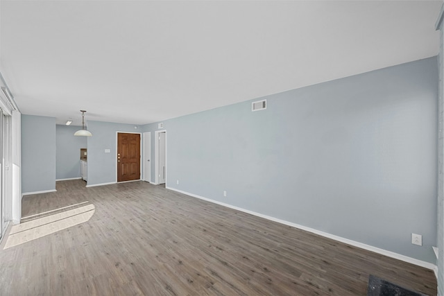 unfurnished living room featuring hardwood / wood-style flooring