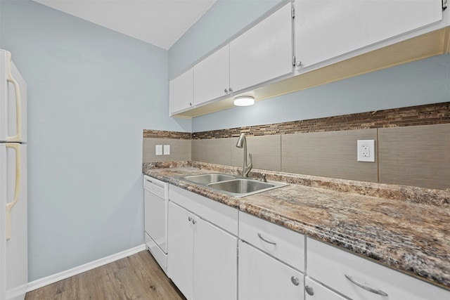 kitchen featuring sink, tasteful backsplash, light wood-type flooring, white appliances, and white cabinets