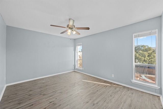 unfurnished room featuring hardwood / wood-style flooring and a healthy amount of sunlight