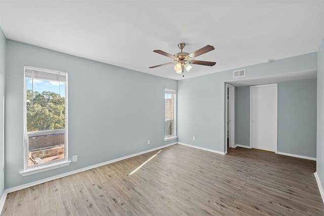 unfurnished room featuring hardwood / wood-style floors and ceiling fan