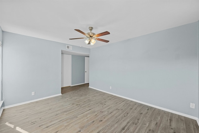 empty room featuring ceiling fan and light hardwood / wood-style flooring