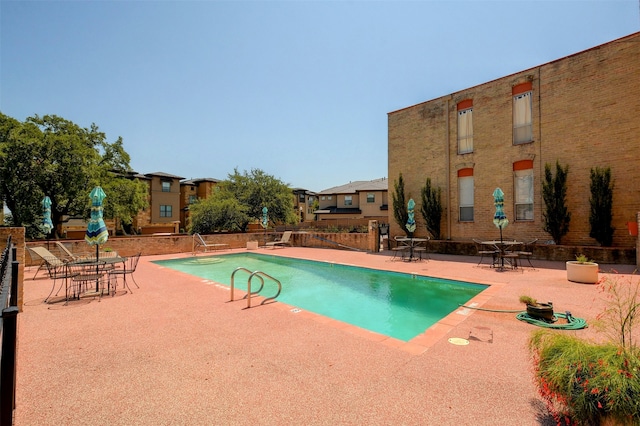 view of swimming pool with a patio