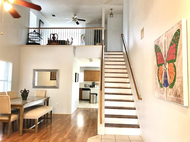 15101 Sweet Caddies Dr, Pflugerville, TX 78660 - stairs with a ceiling fan, a towering ceiling, and wood finished floors