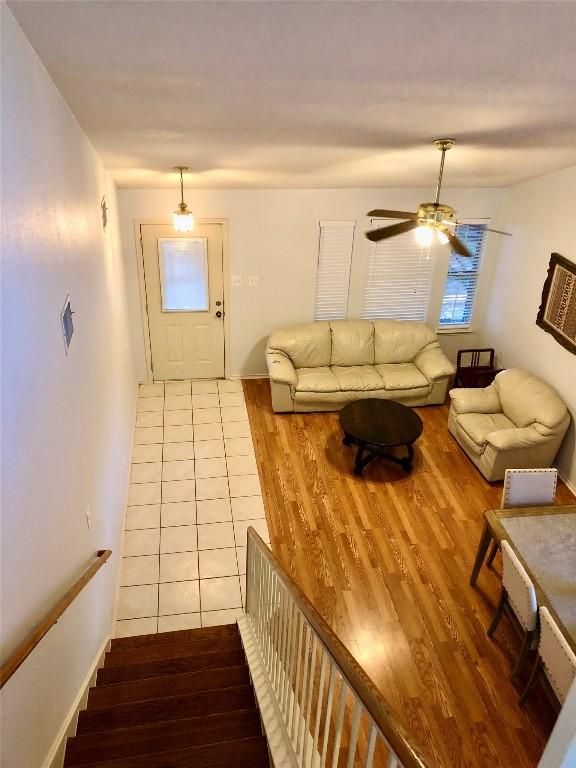15101 Sweet Caddies Dr, Pflugerville, TX 78660 - living area with wood finished floors, a ceiling fan, and stairway
