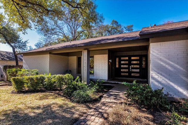 property entrance with brick siding