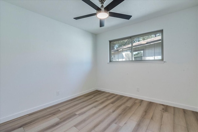 empty room with a ceiling fan, light wood-style floors, and baseboards