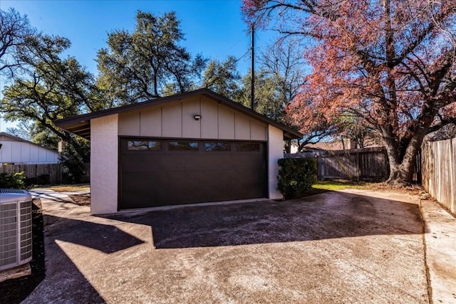 detached garage with central air condition unit and fence