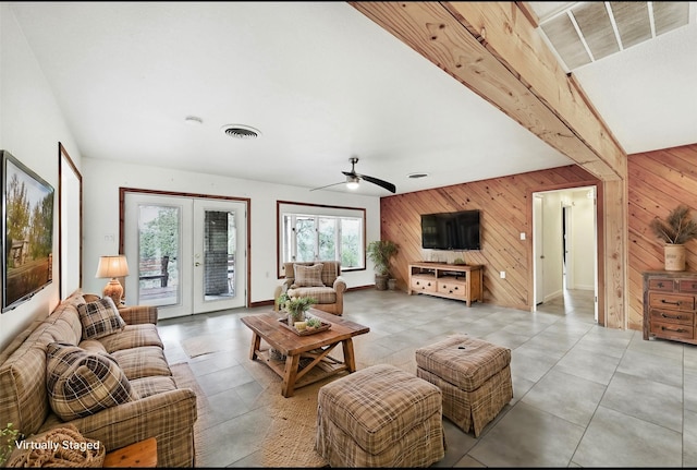 living room with french doors and wooden walls